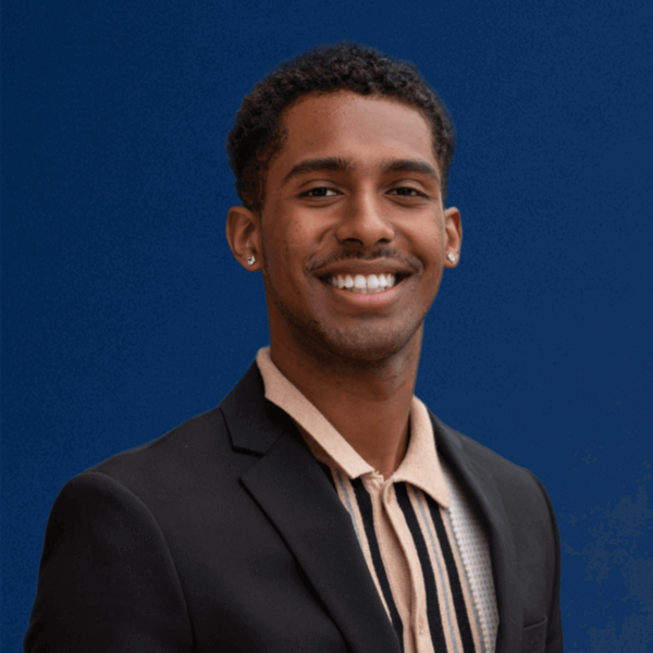 Headshot of Sheedy Family Program Student Jakob Lopez against a blue background.