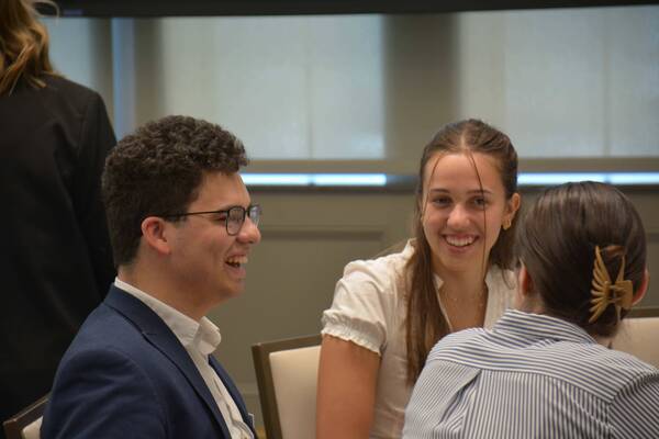 Nathan Ward ('28), Maya Parafiniuk ('28), and Jayne Kelly ('27) at the March 2026 Dinner & Dialogue event
