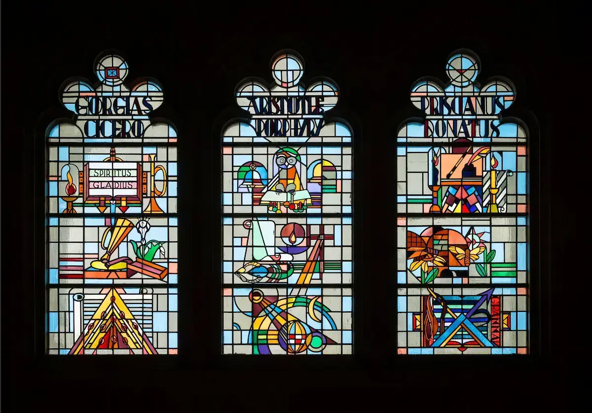 Stained glass windows over the entryway to O’Shaughnessy Hall at the University of Notre Dame depict the “trivium,” or first three liberal arts: grammar, logic, and rhetoric